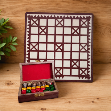Wooden game board with geometric pattern and a box of colorful game pieces on a wooden surface.