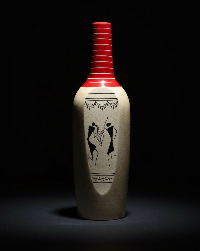 Decorative bottle with red cap and black and white design on a textured surface